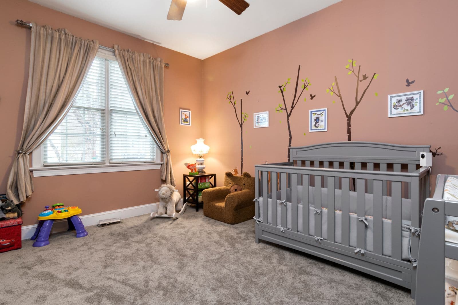 A furnished nursery room with a crib